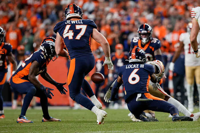 Denver Broncos safety P.J. Locke (6) knocks the ball away from San Francisco 49ers running back Jeff Wilson Jr. (22) as safety Kareem Jackson (22) recovers the fumble and linebacker Josey Jewell (47) looks on in the fourth quarter at Empower Field at Mile High.
